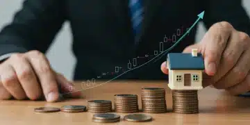 Hand placing house on coins, symbolizing Federal Reserve interest rate hike impact on housing and finances.