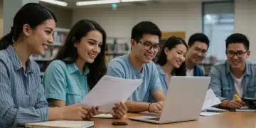 College students reviewing financial aid documents and laptops in a modern library.